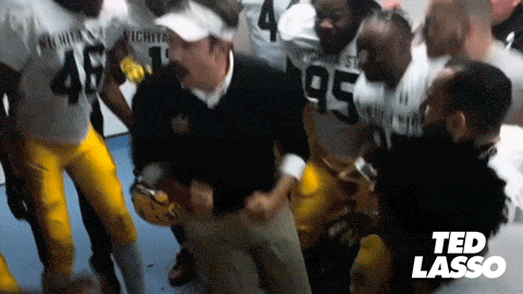 Ted Lasso dancing with the team