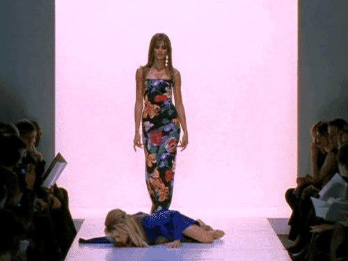 Runway model stepping over a girl on the floor