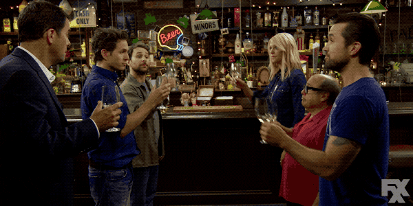 people smashing a glass on the ground at a bar