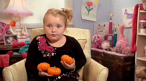 girl trying to juggle pumpkins