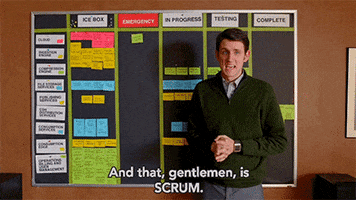 a man in front of a board saying that is scrum gif