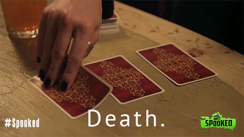 Woman turning over death tarot card