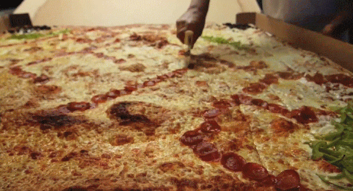 slicing a giant pizza gif
