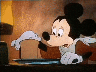 Mickey Mouse slicing very thin pieces of bread
