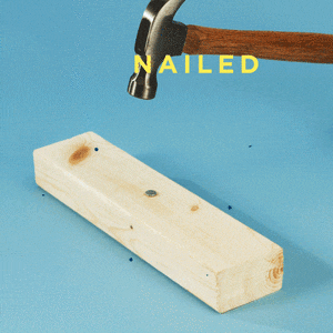 a hammer hitting a nail into a piece of wood