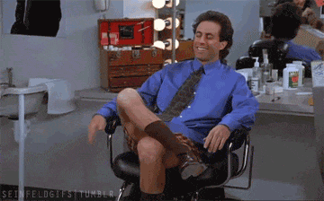Seinfeld sitting on a chair