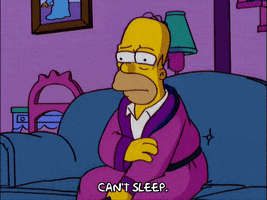 Homer Simpson sitting on the couch saying he can't sleep