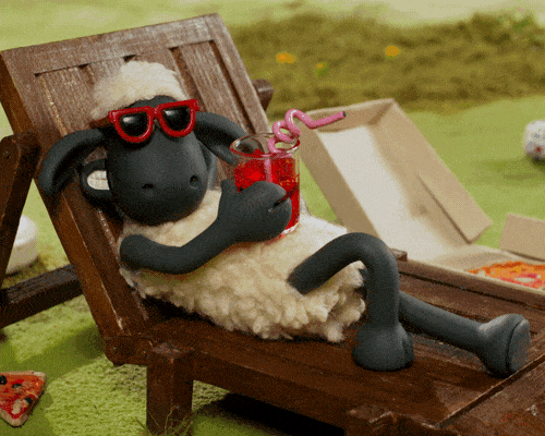 A sheep wearing red sunglasses and drinking a cocktail 