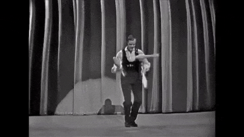 Man juggling on stage black and white gif