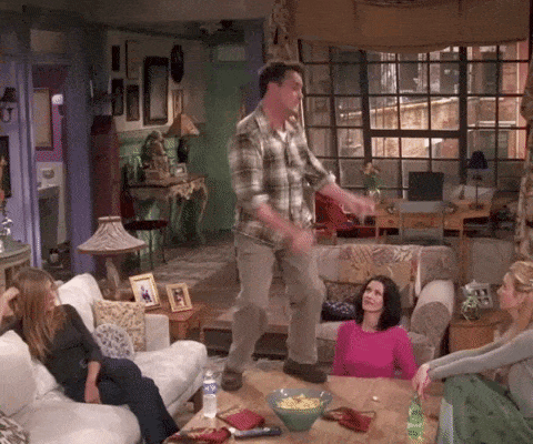 Chandler from Friends dancing on top of a coffee table