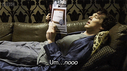 Sherlock Holmes laying down on the couch reading a magazine saying no