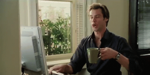 Bruce Almighty Jim Carey typing fast and drinking coffee