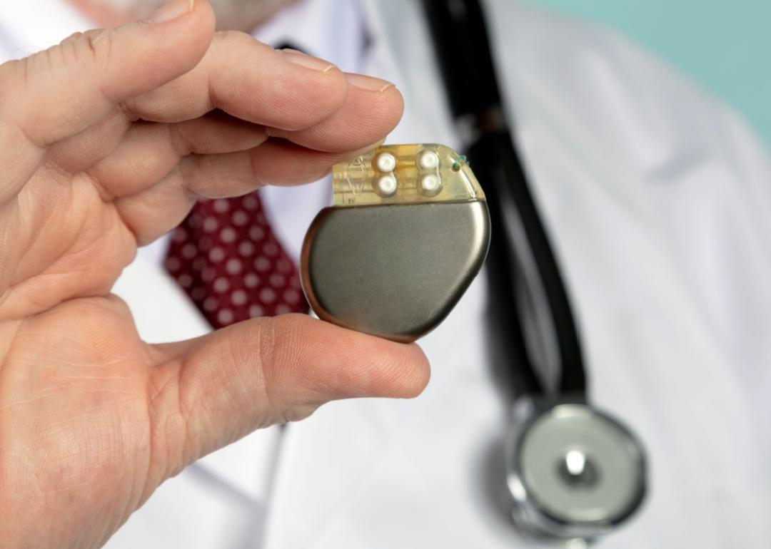 A doctor holding a pacemaker 