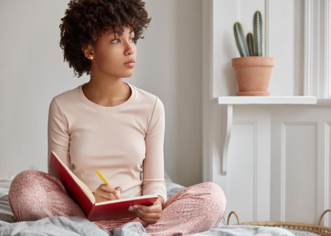 A woman writing in a notebook