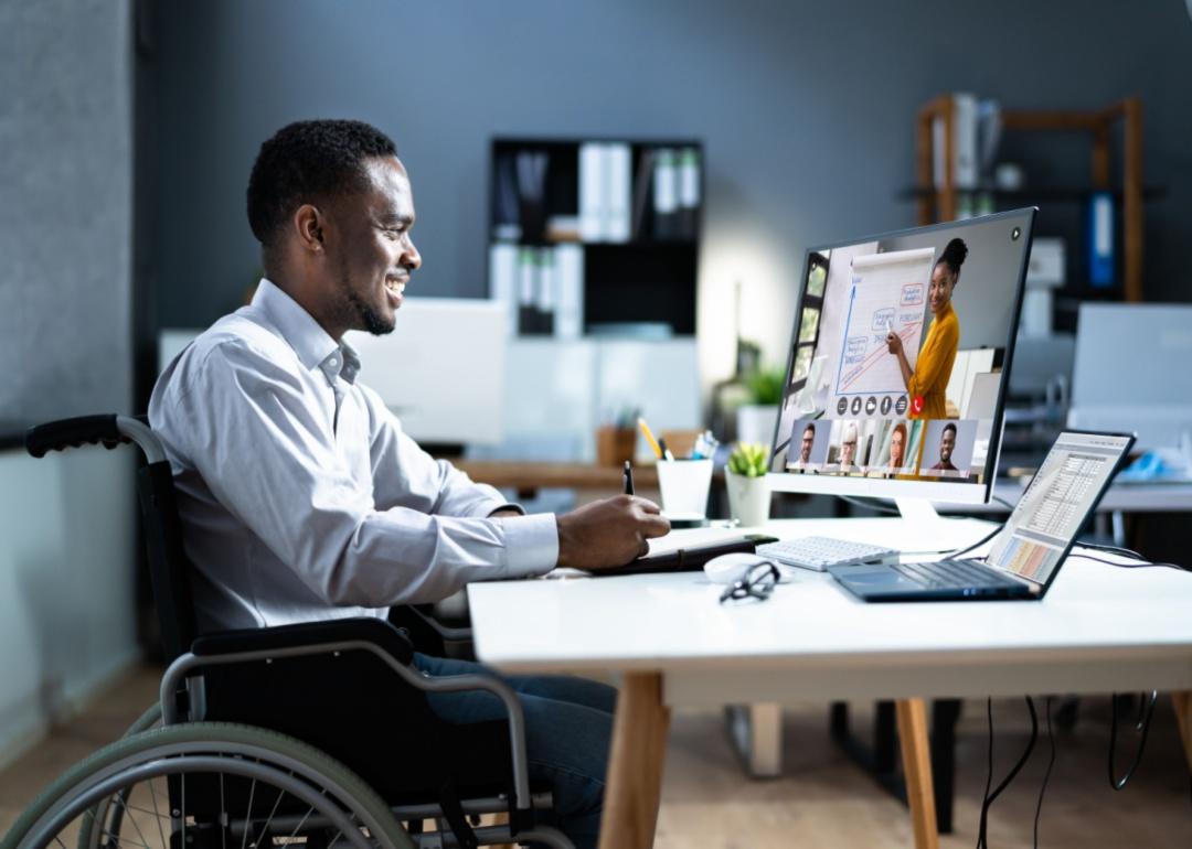 A man participating in a remote meeting with his colleagues