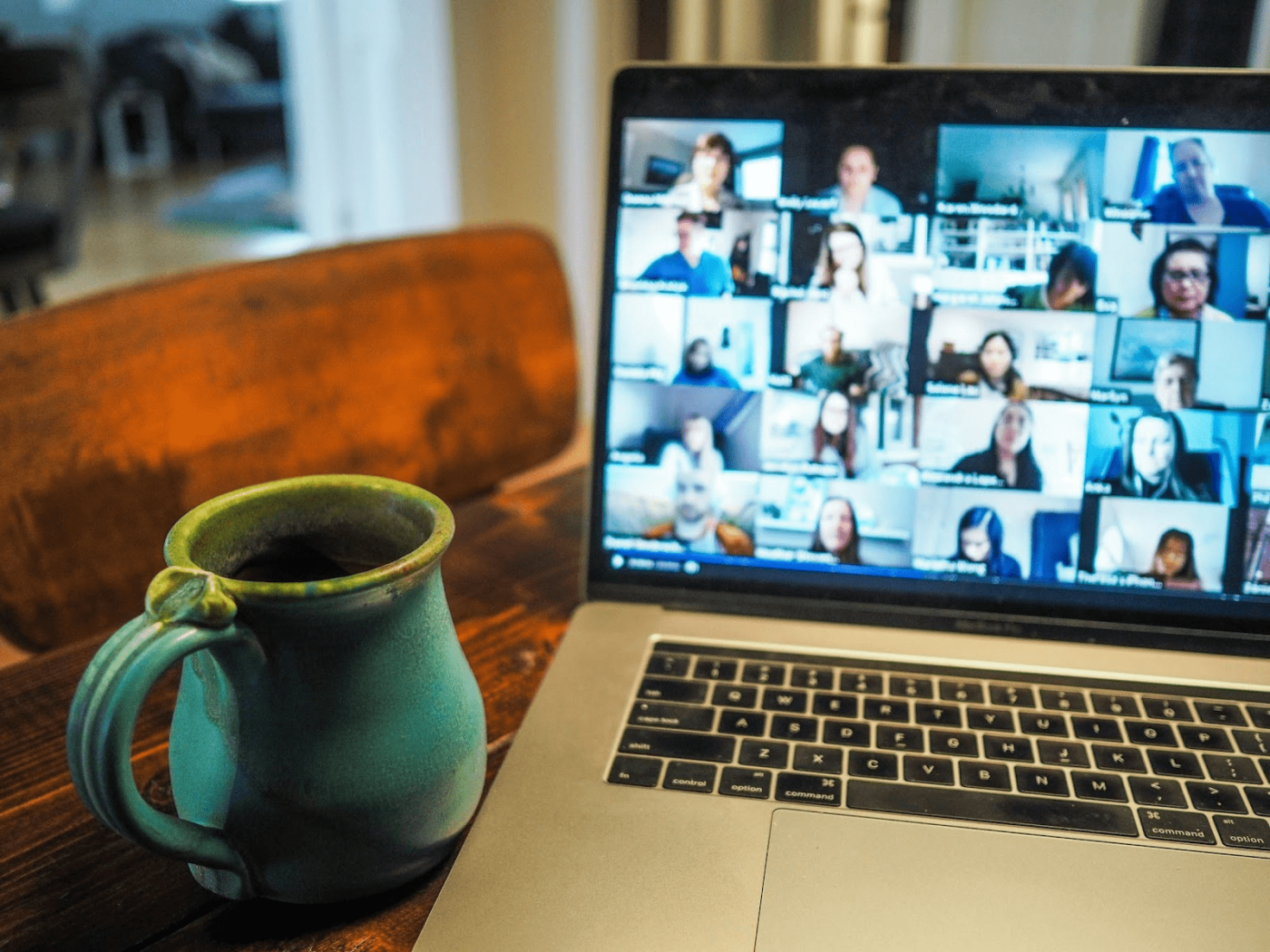 Zoom meeting on a laptop screen - overcommunication at work is more important for remote teams