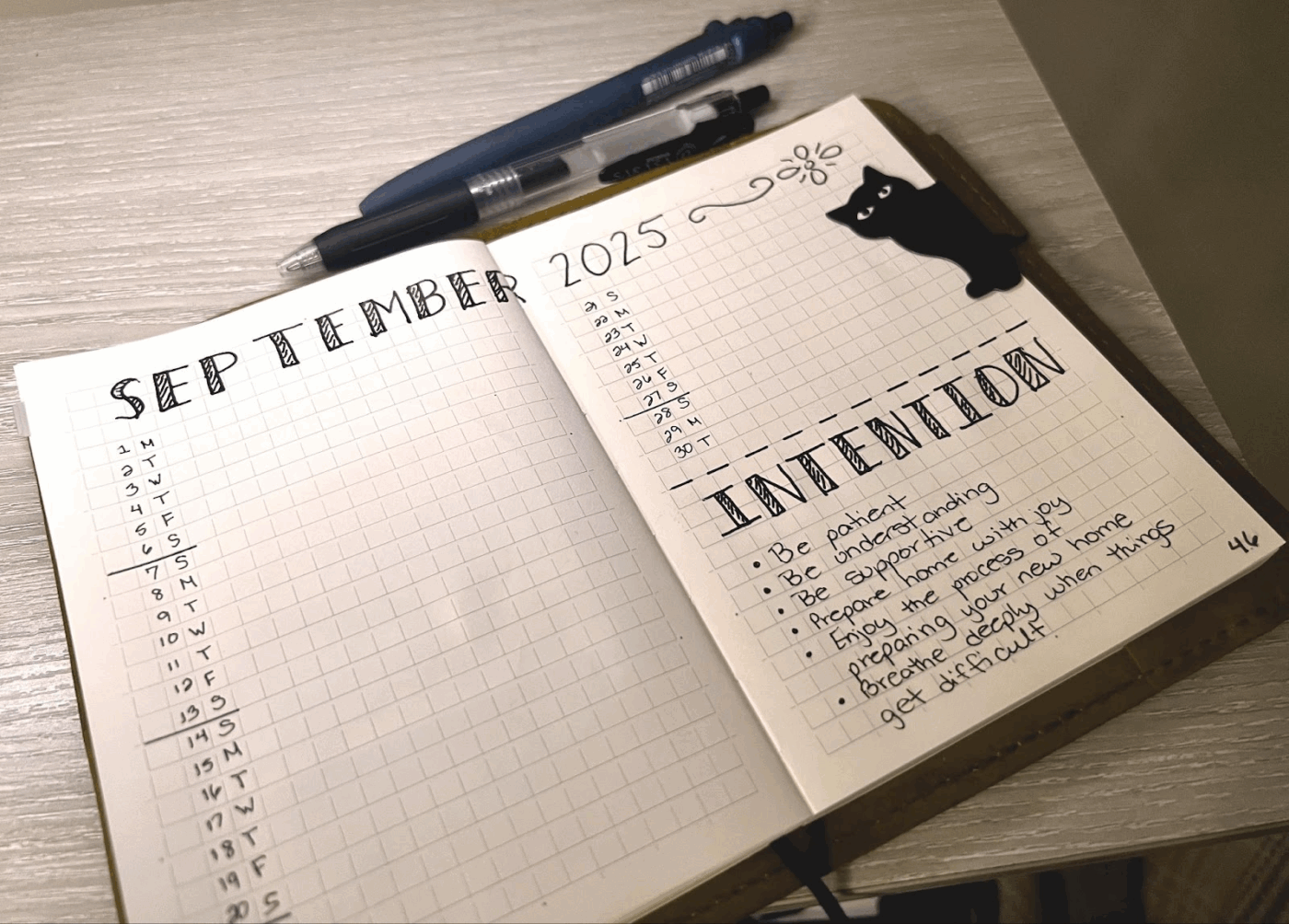 A calming, minimalist bullet journal monthly spread with an intention section, offering a tactile escape from digital overload